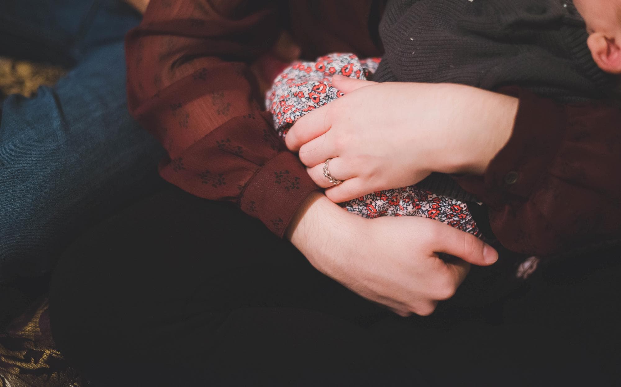 Closeup of mom's hands holding newborn lifestyle session